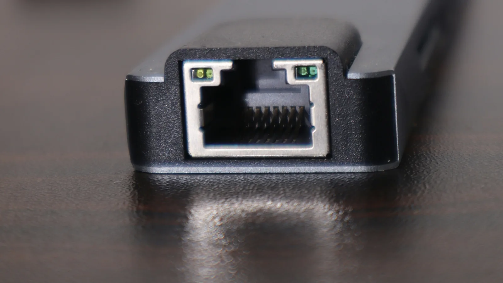Close-up of a router's ethernet port on a wooden desk