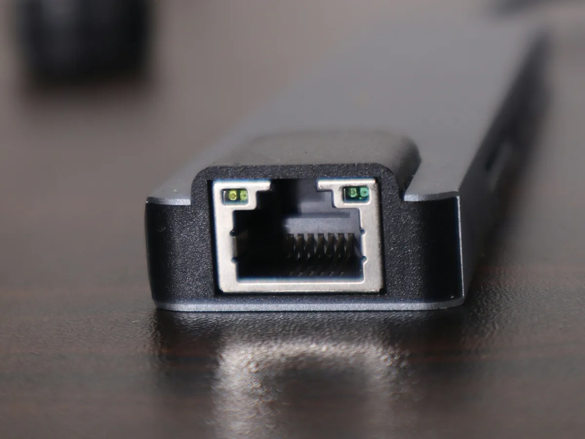 Close-up of a router's ethernet port on a wooden desk